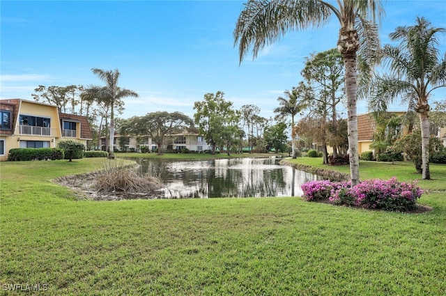 exterior space with a lawn and a water view