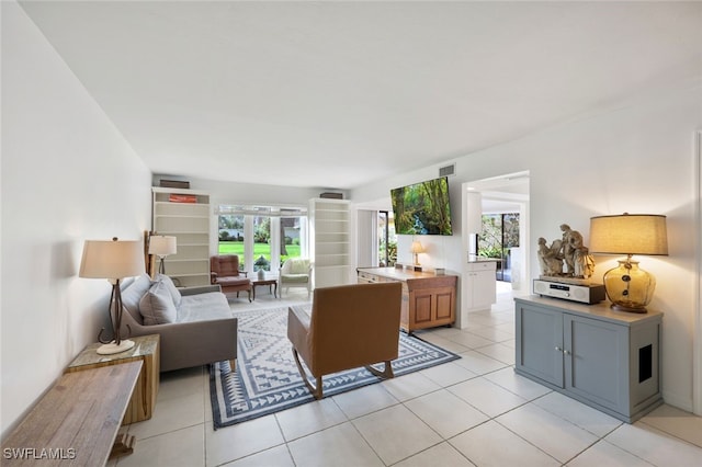 living room featuring light tile patterned floors and plenty of natural light