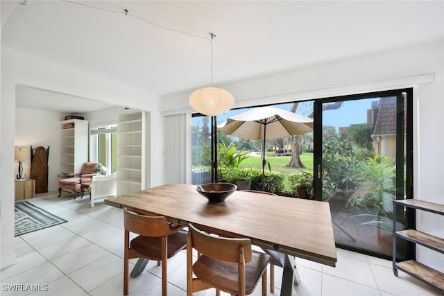 dining area featuring a wealth of natural light and light tile patterned floors