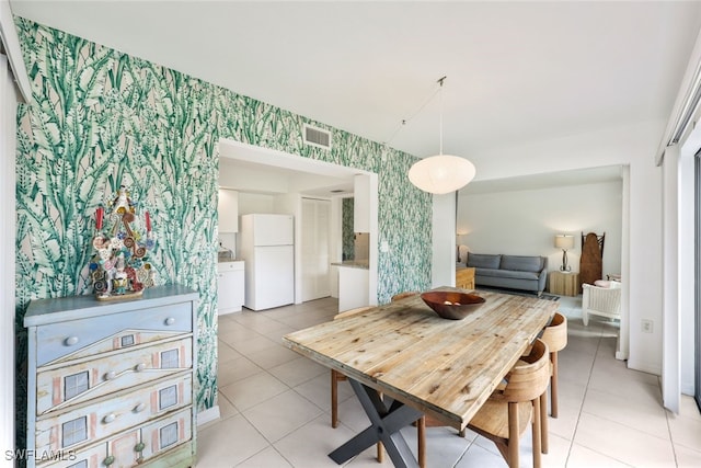 dining space featuring light tile patterned flooring