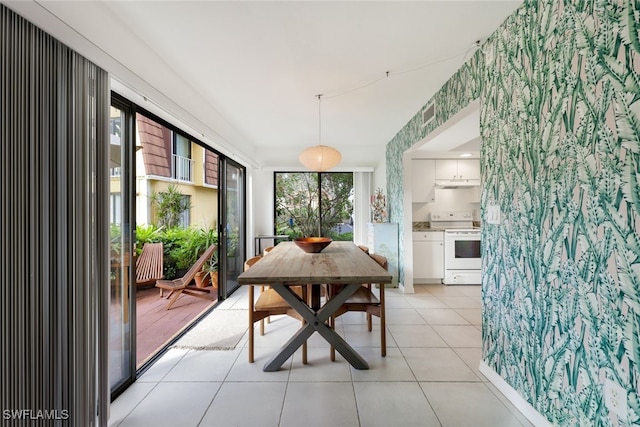 dining room with a healthy amount of sunlight and light tile patterned flooring