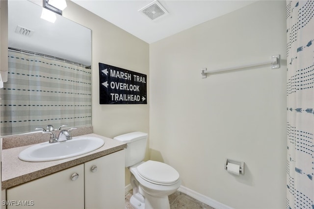 bathroom with walk in shower, vanity, and toilet