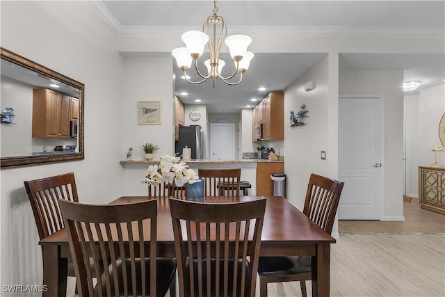 dining space with crown molding and a chandelier