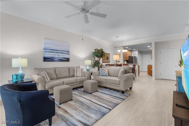 living room featuring crown molding and ceiling fan with notable chandelier