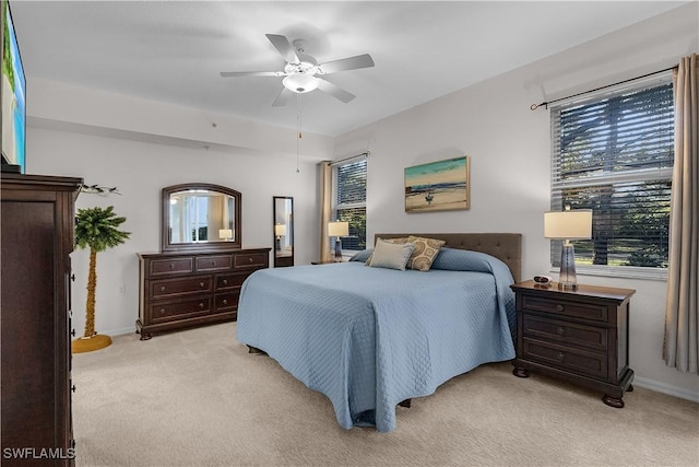 bedroom featuring light colored carpet and ceiling fan