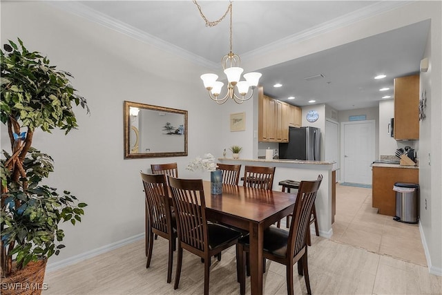 dining area featuring crown molding, a chandelier, and light tile patterned floors