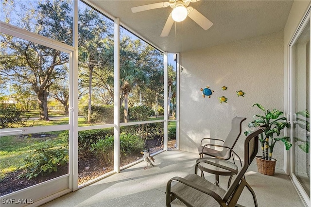 sunroom / solarium featuring ceiling fan