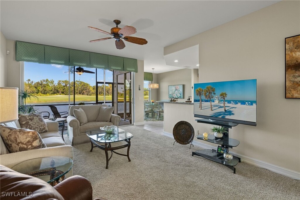 21511 Pelican Sound Dr Unit 102, Estero, FL 33928 - living room featuring ceiling fan and light carpet