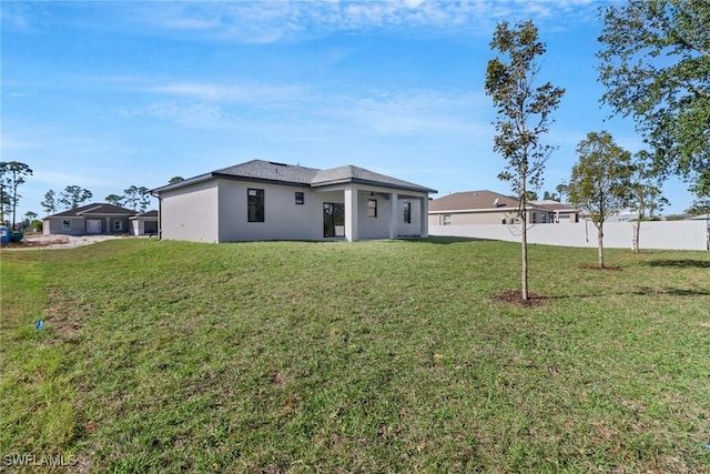 back of house with a yard