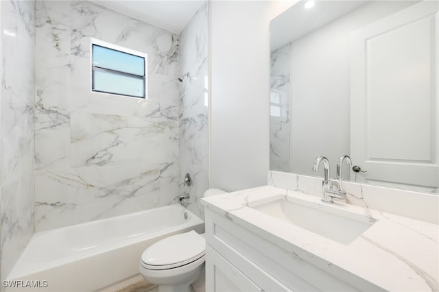 full bathroom featuring tiled shower / bath combo, toilet, and vanity