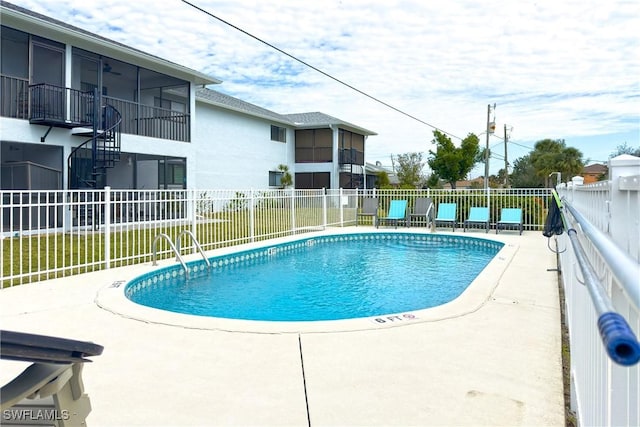 view of swimming pool featuring a sunroom and a patio