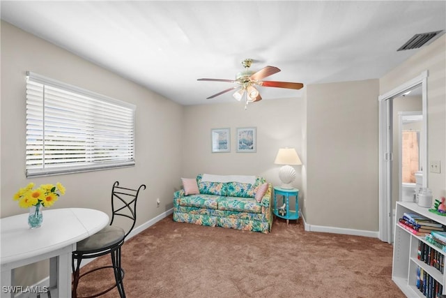 interior space featuring ceiling fan and light colored carpet