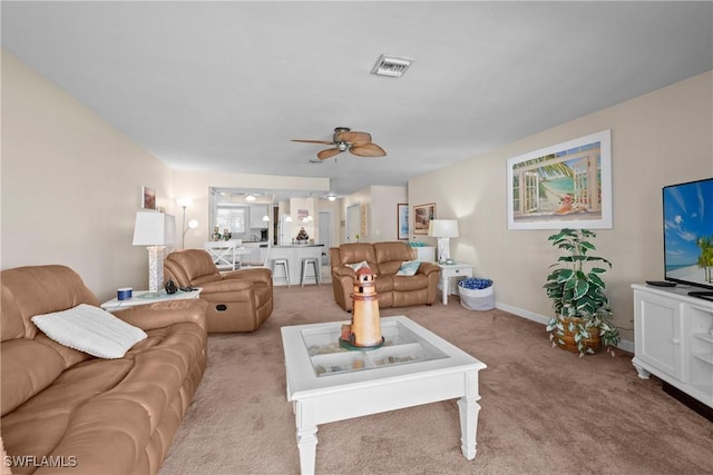 carpeted living room featuring ceiling fan