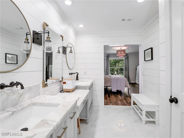 ensuite bathroom featuring connected bathroom, visible vents, a sink, and double vanity