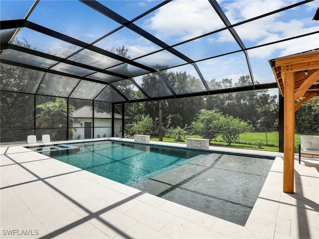 view of pool featuring a patio area, a pool with connected hot tub, and glass enclosure