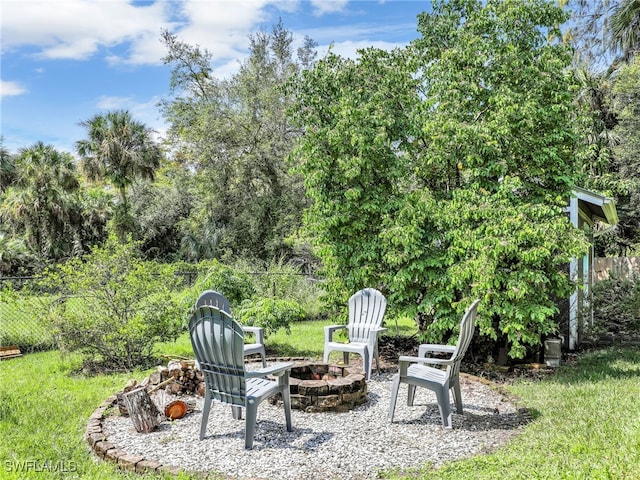 view of yard with an outdoor fire pit, fence, and a patio