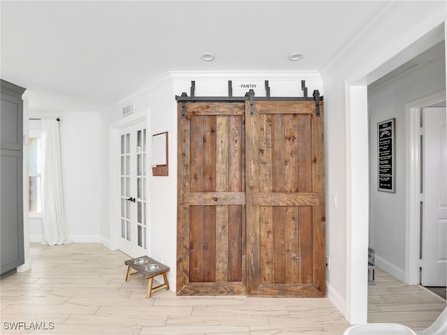 room details with ornamental molding, wood finished floors, visible vents, and baseboards