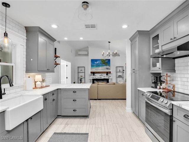 kitchen featuring electric range, gray cabinets, and a sink