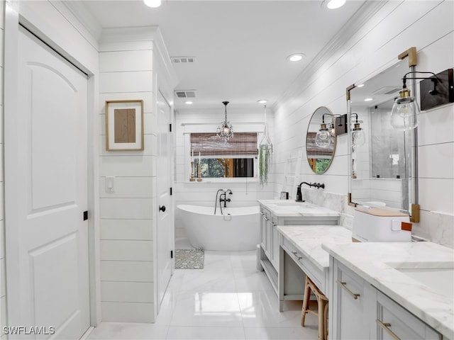 bathroom with a soaking tub, visible vents, and vanity