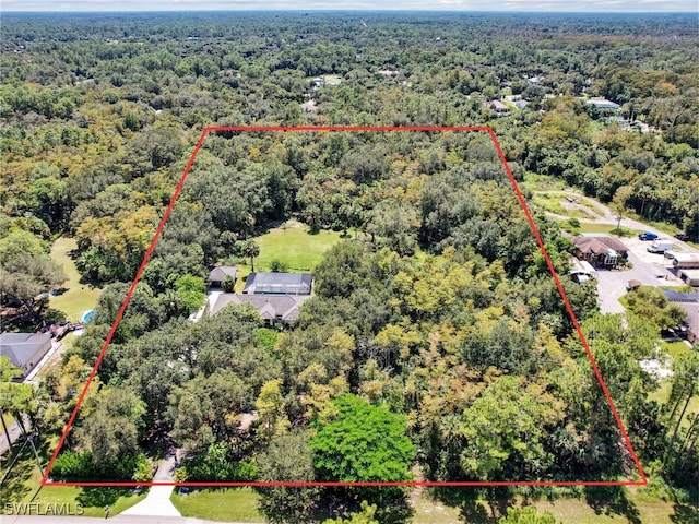 birds eye view of property with a forest view