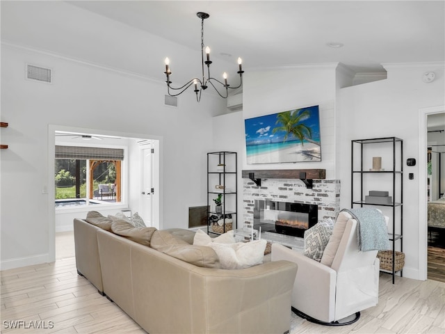 living area with light wood-style floors, a fireplace, visible vents, and crown molding