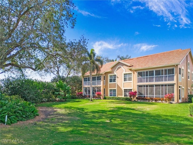 back of house with a lawn