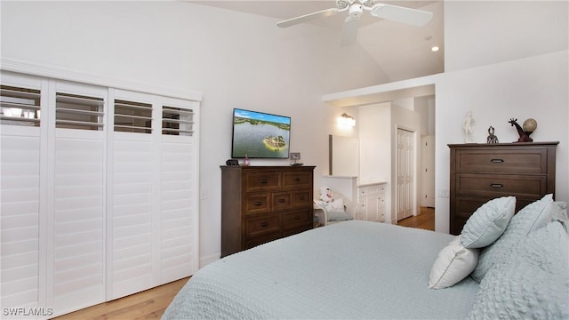 bedroom featuring light wood-type flooring, high vaulted ceiling, and ceiling fan