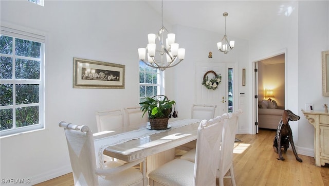 dining room featuring light hardwood / wood-style floors and a notable chandelier