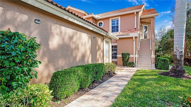 property entrance with a lawn