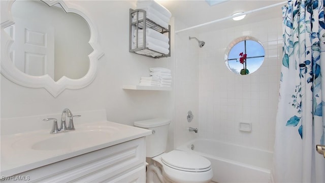 full bathroom featuring vanity, shower / bathtub combination with curtain, and toilet