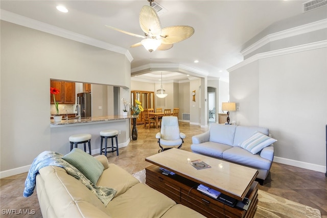 tiled living room featuring ceiling fan and crown molding