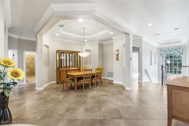 dining room featuring a tray ceiling and ornamental molding