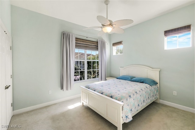 bedroom featuring ceiling fan and light carpet