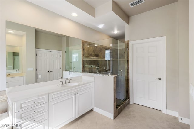 bathroom with tile patterned flooring, vanity, and a shower with shower door