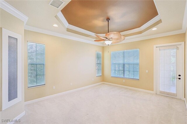 25970 Nesting Ct Unit 201, Bonita Springs, FL 34134 - empty room featuring a tray ceiling, ornamental molding, light colored carpet, baseboards, and a ceiling fan