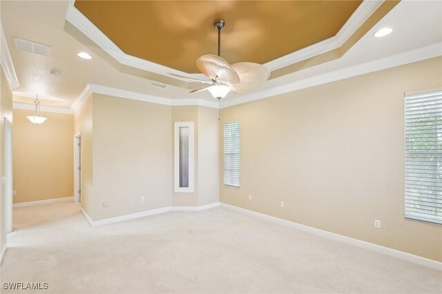 25970 Nesting Ct Unit 201, Bonita Springs, FL 34134 - spare room with a raised ceiling, carpet flooring, crown molding, ceiling fan, and baseboards