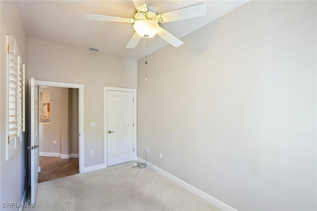 25970 Nesting Ct Unit 201, Bonita Springs, FL 34134 - unfurnished bedroom featuring carpet, baseboards, ceiling fan, and lofted ceiling
