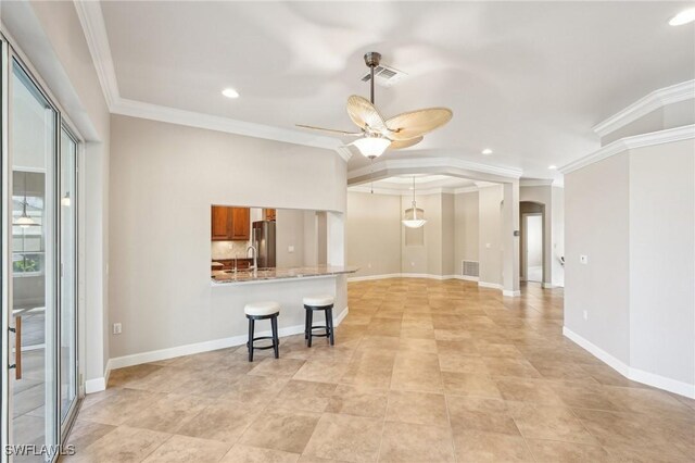 25970 Nesting Ct Unit 201, Bonita Springs, FL 34134 - unfurnished living room with ceiling fan, crown molding, recessed lighting, arched walkways, and a sink