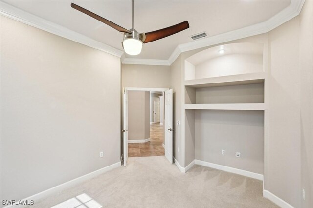 25970 Nesting Ct Unit 201, Bonita Springs, FL 34134 - unfurnished bedroom featuring crown molding, light carpet, baseboards, and a ceiling fan