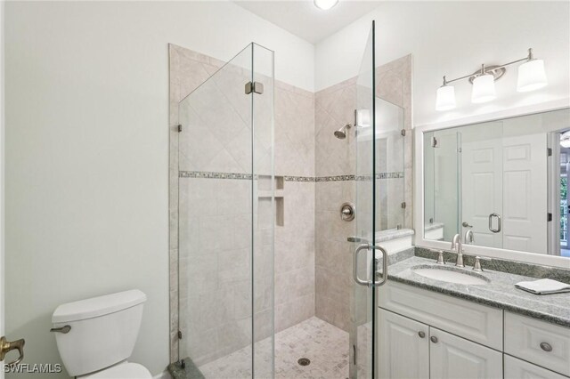 25970 Nesting Ct Unit 201, Bonita Springs, FL 34134 - full bathroom with a stall shower, toilet, and vanity