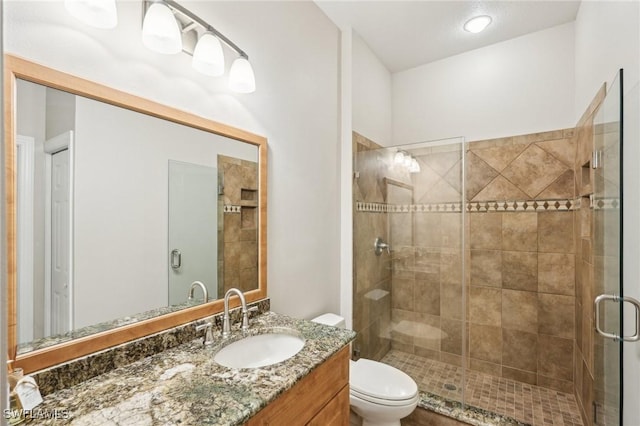 25970 Nesting Ct Unit 201, Bonita Springs, FL 34134 - bathroom featuring a stall shower, toilet, and vanity