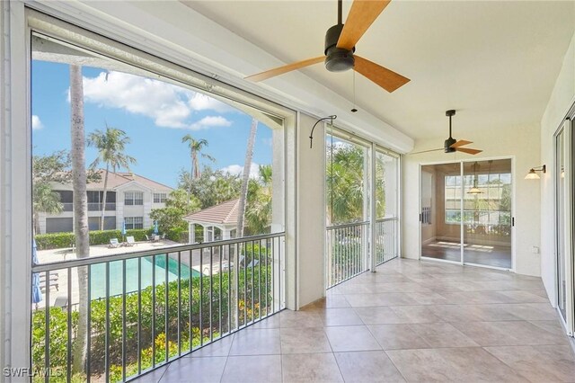 25970 Nesting Ct Unit 201, Bonita Springs, FL 34134 - unfurnished sunroom featuring a ceiling fan and tile patterned floors