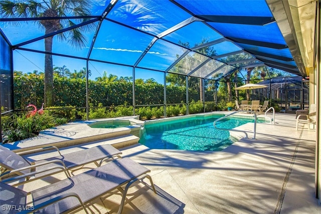 view of swimming pool with a patio area, an in ground hot tub, and glass enclosure