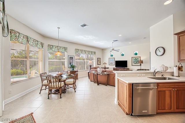 kitchen featuring light tile patterned floors, decorative light fixtures, ceiling fan, and sink