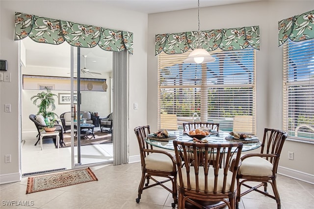 tiled dining room with ceiling fan and a wealth of natural light