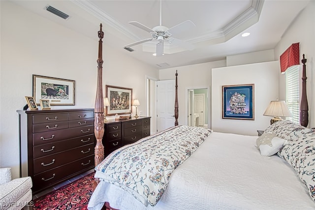 bedroom with a raised ceiling, ceiling fan, and ornamental molding