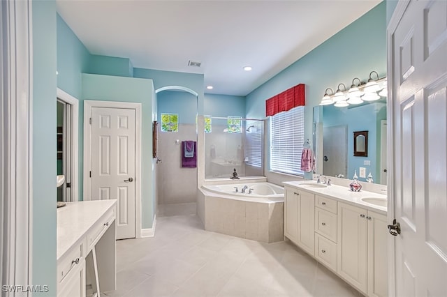 bathroom with tile patterned flooring, vanity, and shower with separate bathtub