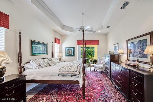 bedroom with a tray ceiling, ceiling fan, and crown molding