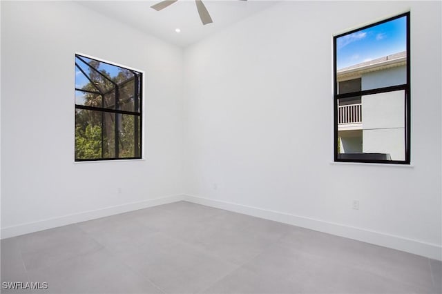 spare room with a wealth of natural light and ceiling fan