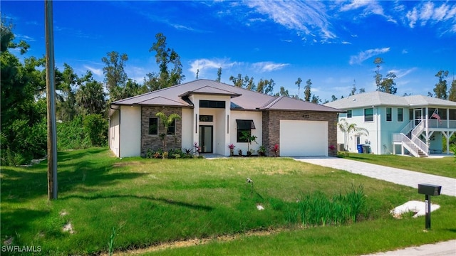 view of front of home with a front lawn and a garage